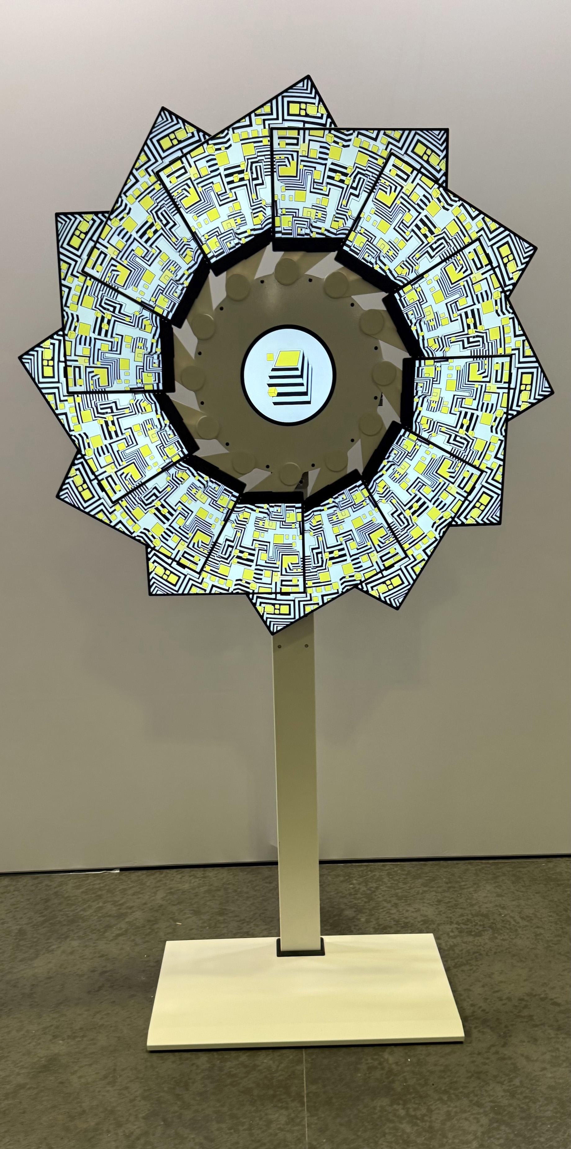The Atlas of Perception radial display - a circular arrangement of 13 monitors showing continuous visualization of neural network features
